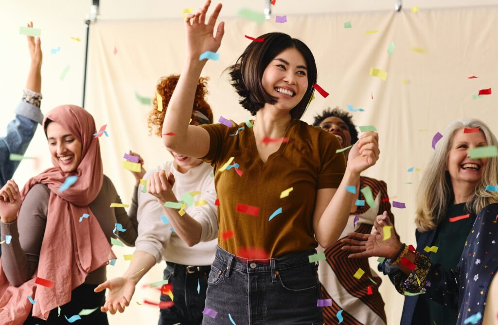 Action shot of mixed age multiethnic women celebrating International Women's Day