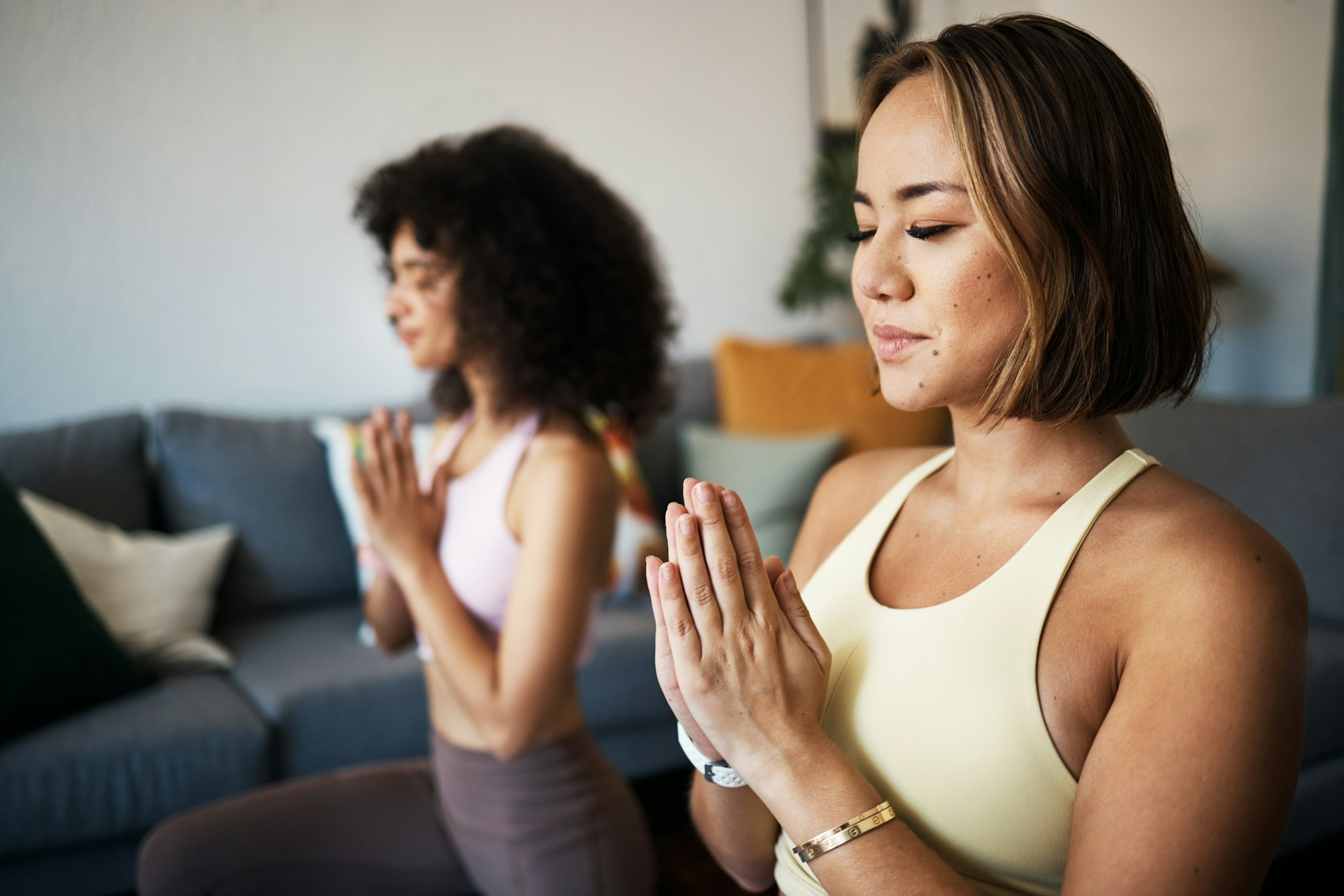 Women, fitness friends and meditation with namaste or prayer hands, mindfulness, wellness and peace